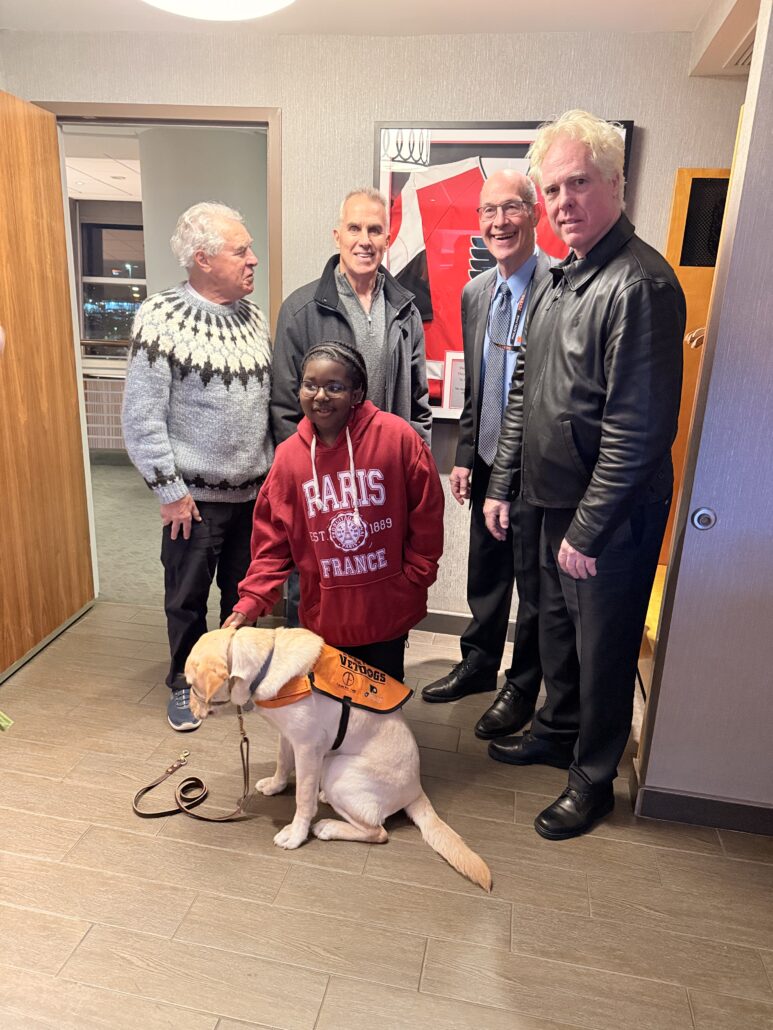 Raymeer with service dog and members of Flyers Alumni
