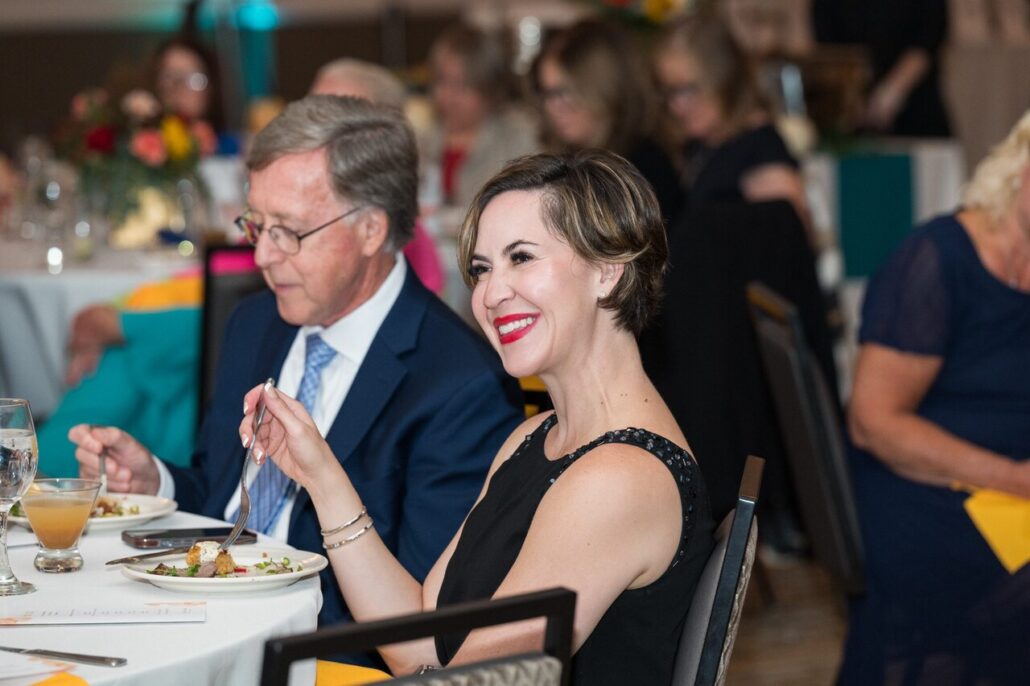Two formally dressed attendees at the 2024 Live It Up! gala supporting Help Hope Live.
