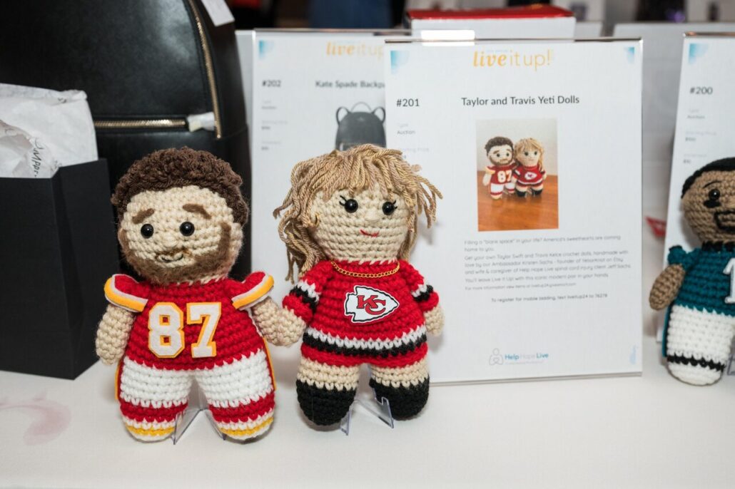 Travis Kelce and Taylor Swift crochet dolls in the silent auction made by Yeti or Knot at the 2024 Live It Up! gala supporting Help Hope Live.