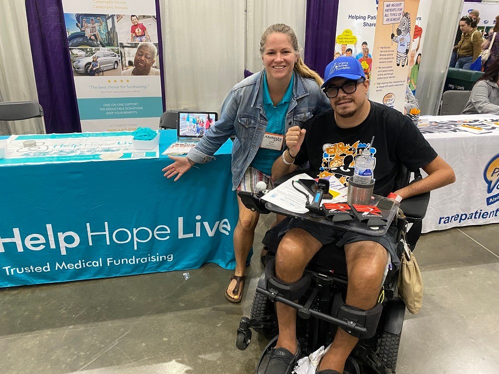 Sonny with Help Hope Live client Gary Bolton in his power chair at Abilities Expo Houston 2024.