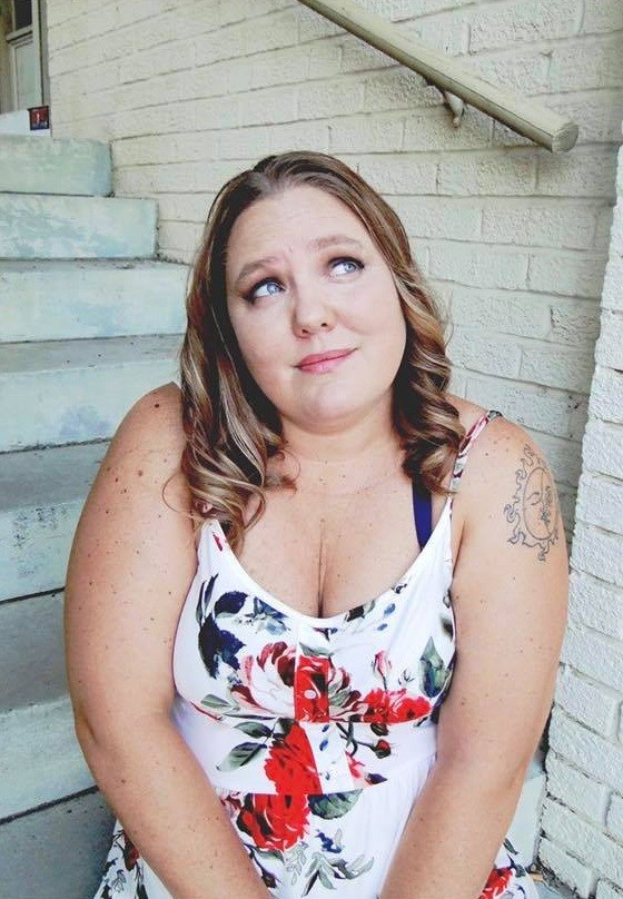 Help Hope Live client Jamie Carlson aka the "Cerebral Palsy Quilter" looks up pensively in a portrait.
