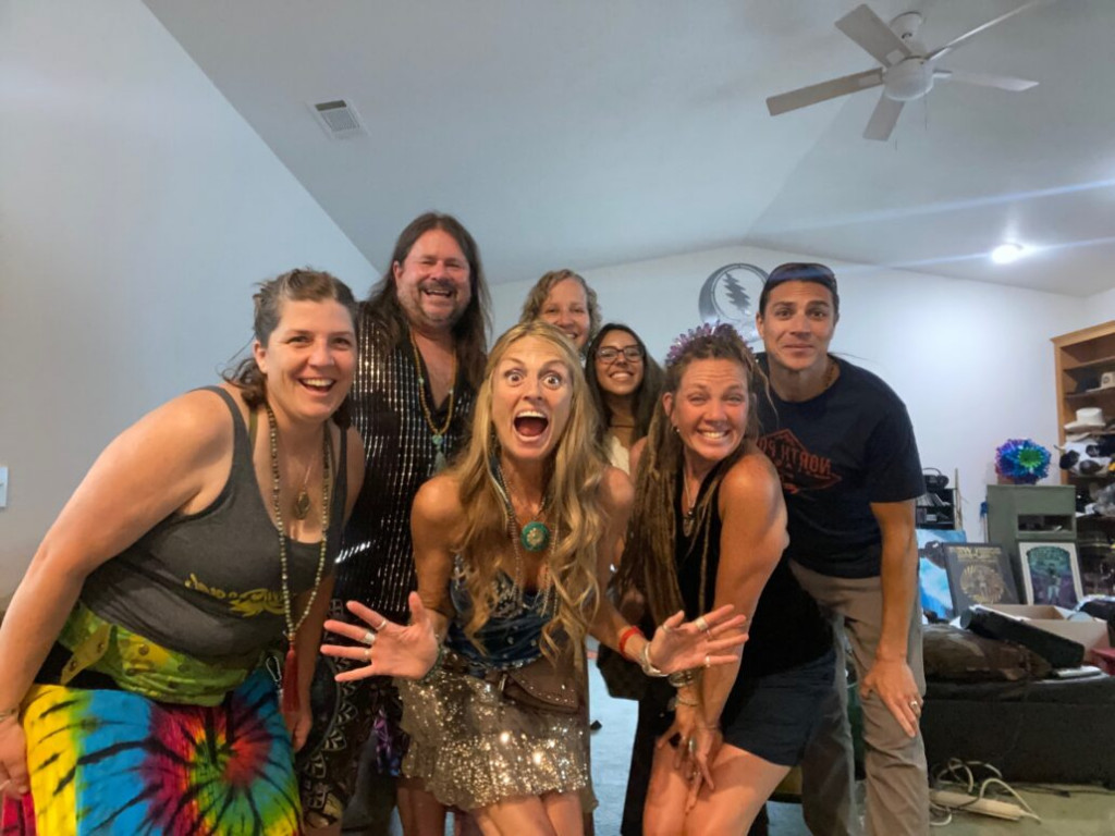 Noelle Doughty and five loved ones smile and pose together indoors