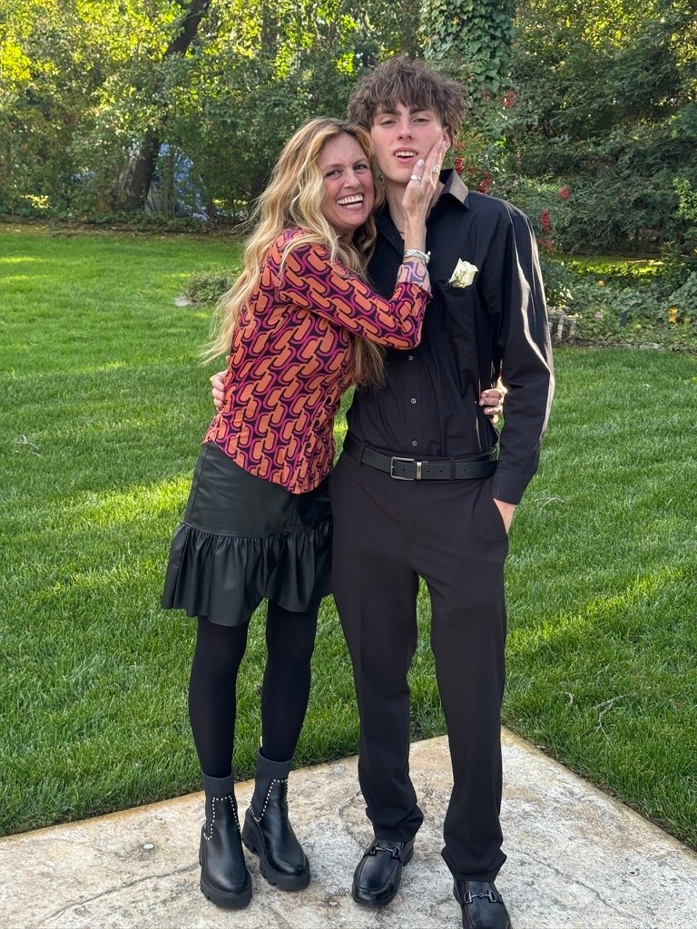 Noelle Doughty smiles while embracing a young man outdoors