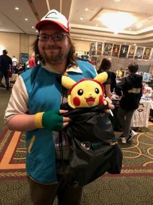 A New Jersey Gamer Con attendee is cosplaying as a Pokemon trainer