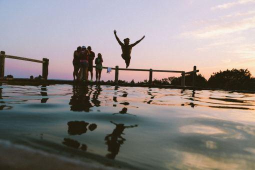 Diving off a pier in twilight