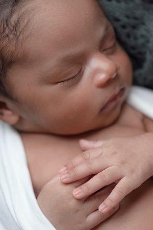 A stock a newborn baby with light brown skin