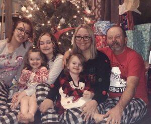 A Help Hope Live client family at Christmas in matching pajamas.