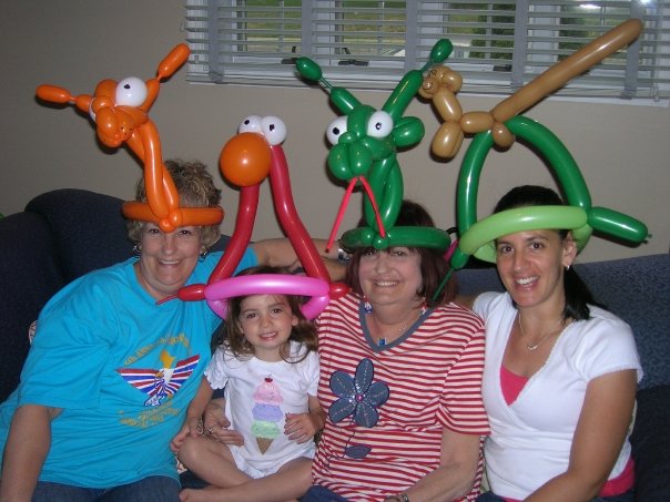 Kelly Green with her mother, who needed a kidney transplant, and her young daughter. They wear giant balloon animal hats.