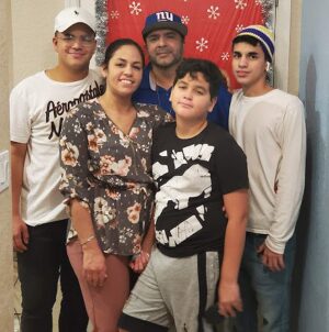 Live transplant recipient Yolanda Rodriguez is pictured with her family. She has light brown skin and dark hair and eyes.