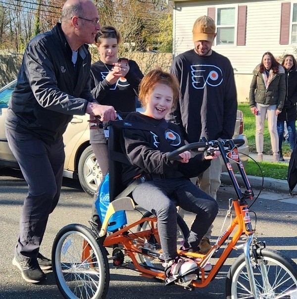 Brad Marsh pushing Raelynn on her bike