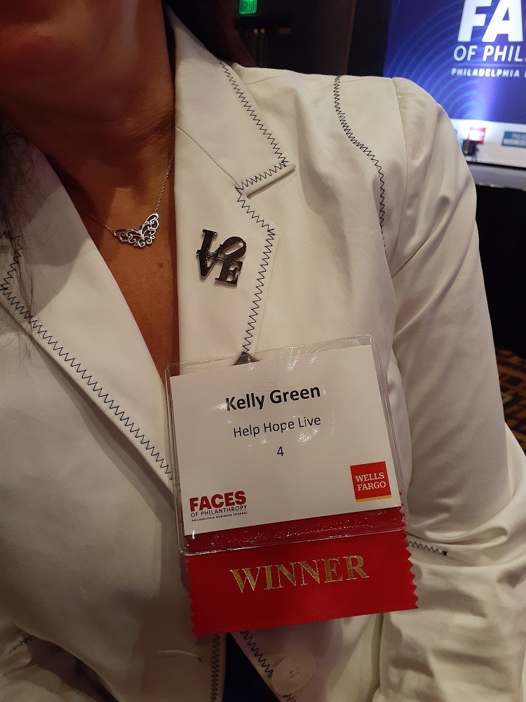 Kelly Green wearing a winner badge at the Faces of Philanthropy Awards.