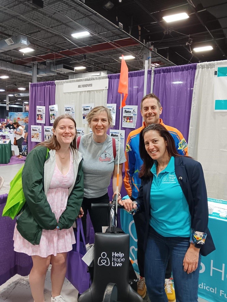 Kelly Green is pictured with members of the Rosenblatt Foundation and a Freedom Concepts representative with a Help Hope Live-themed adaptive bike at Abilities Expo NY Metro.