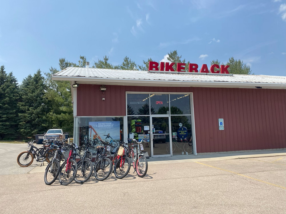 The exterior of The Bike Rack in Chicago: a red building with a large red BIKE RACK sign on its roof and half a dozen bikes parked outside.