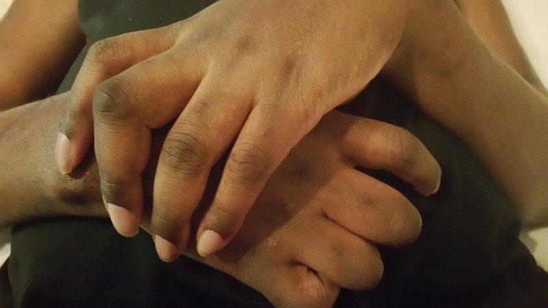 A close-up of Stephany's hands, slightly curled.