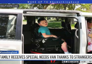 12-year-old Stephen Carr McGrath is in his power chair inside his family's new accessible van with a sliding door.