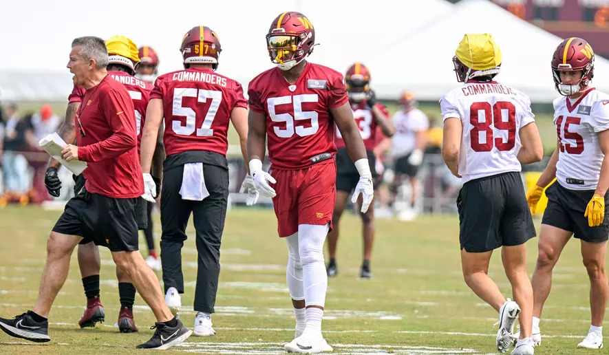 KJ Henry wears number 55 in his red Washington Commanders NFL uniform during a practice.