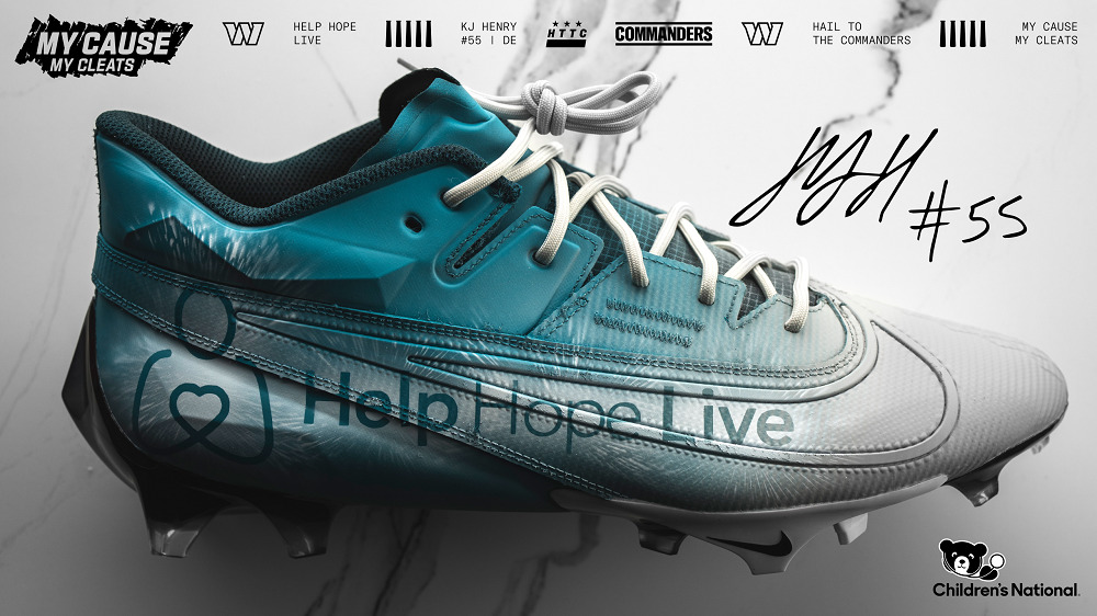 A Help Hope Live branded right cleat in a promotional image from the Commanders. The image is signed by KJ Henry and features the My Cause My Cleats logo. The cleat reads Help Hope Live on the side with teal, white, and gray ombre detail.