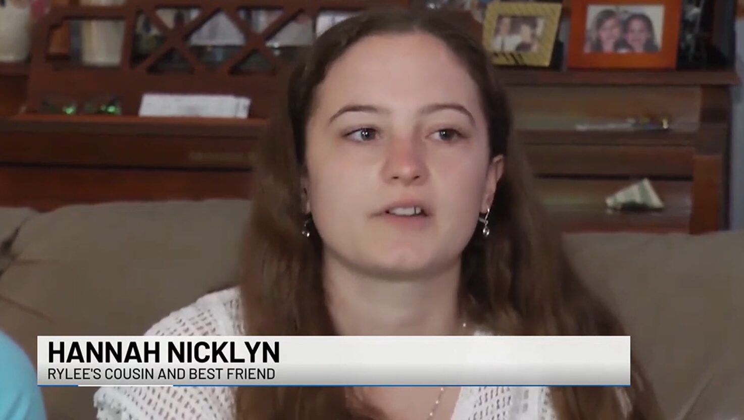 Future kidney donor to 23-year-old Rylee Wobio Hannah Nicklyn is pictured in a screenshot from a TV interview. The ticker reads Rylee's Cousin and Best Friend. Hannah has light skin, curly brown hair, and dark eyes.