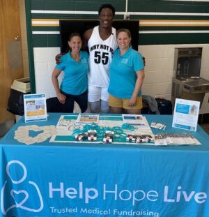 Washington Commanders player KJ Henry with Kelly L Green and Sonny Mullen from Help Hope Live.