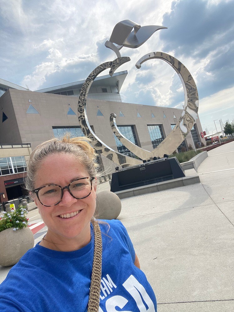 A selfie of Sonny in Atlanta with a large silver peach statue.