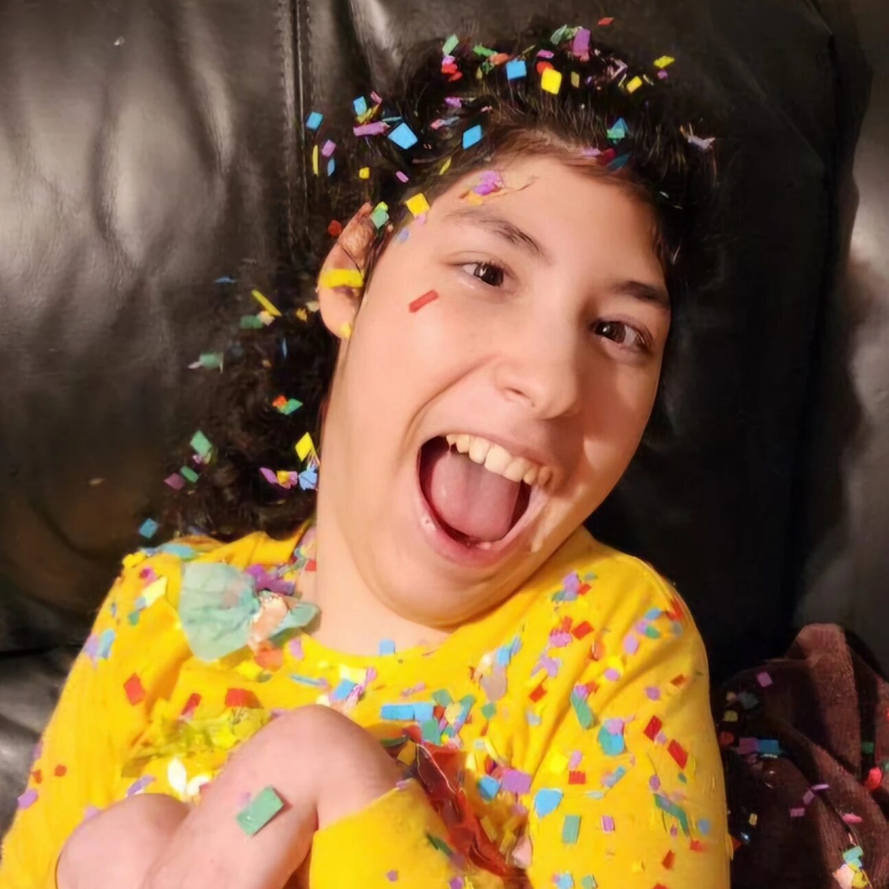Gabriela Buentello smiles while covered in confetti.