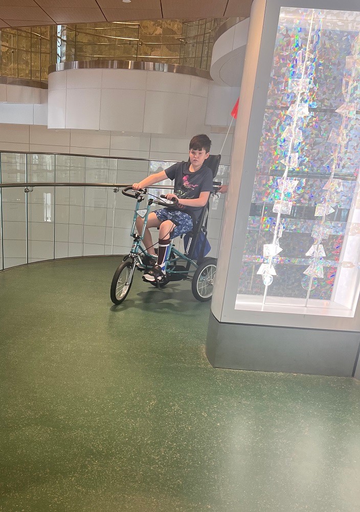 12-year-old Tommy Schrank rides an adaptive bike.