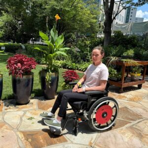 Cathleen Driscoll seated in her wheelchair outside.