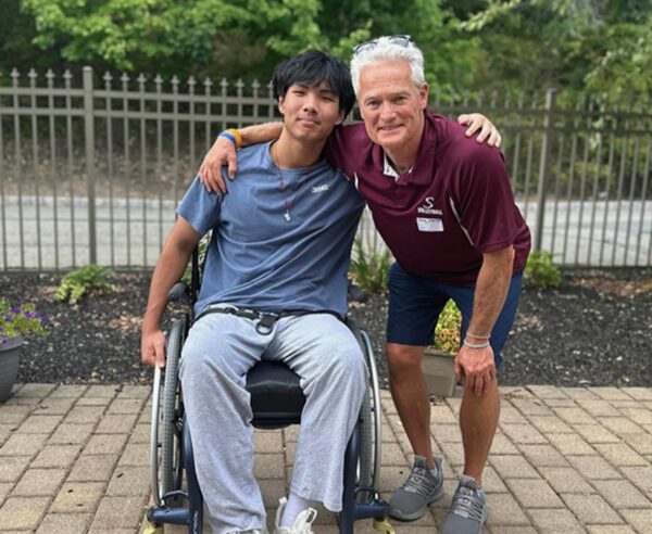 18-year-old Jonathan Liang seated in his wheelchair.