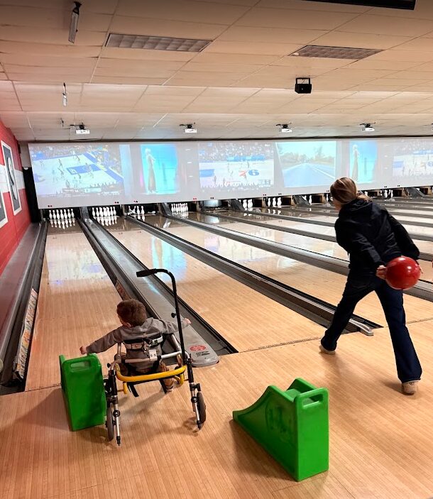 Brooke Schostak bowls with 3-year-old Sidney Schmid.