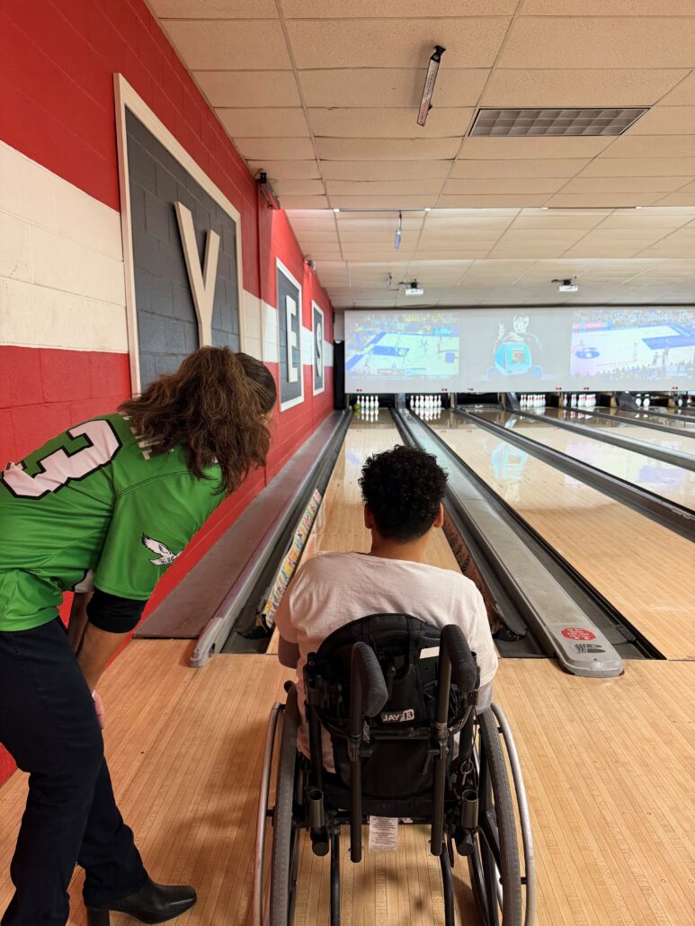 Kelly L Green bowls with 12-year-old Kelson Williams.