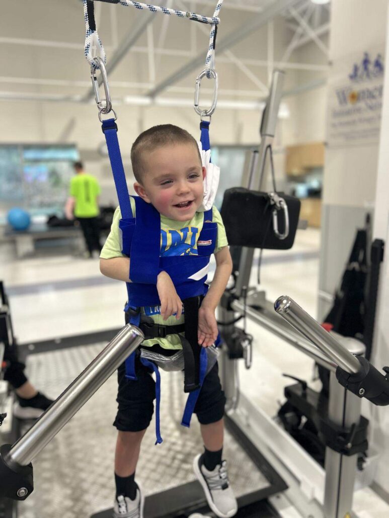 Logan Reese upright in a rehabilitation environment.