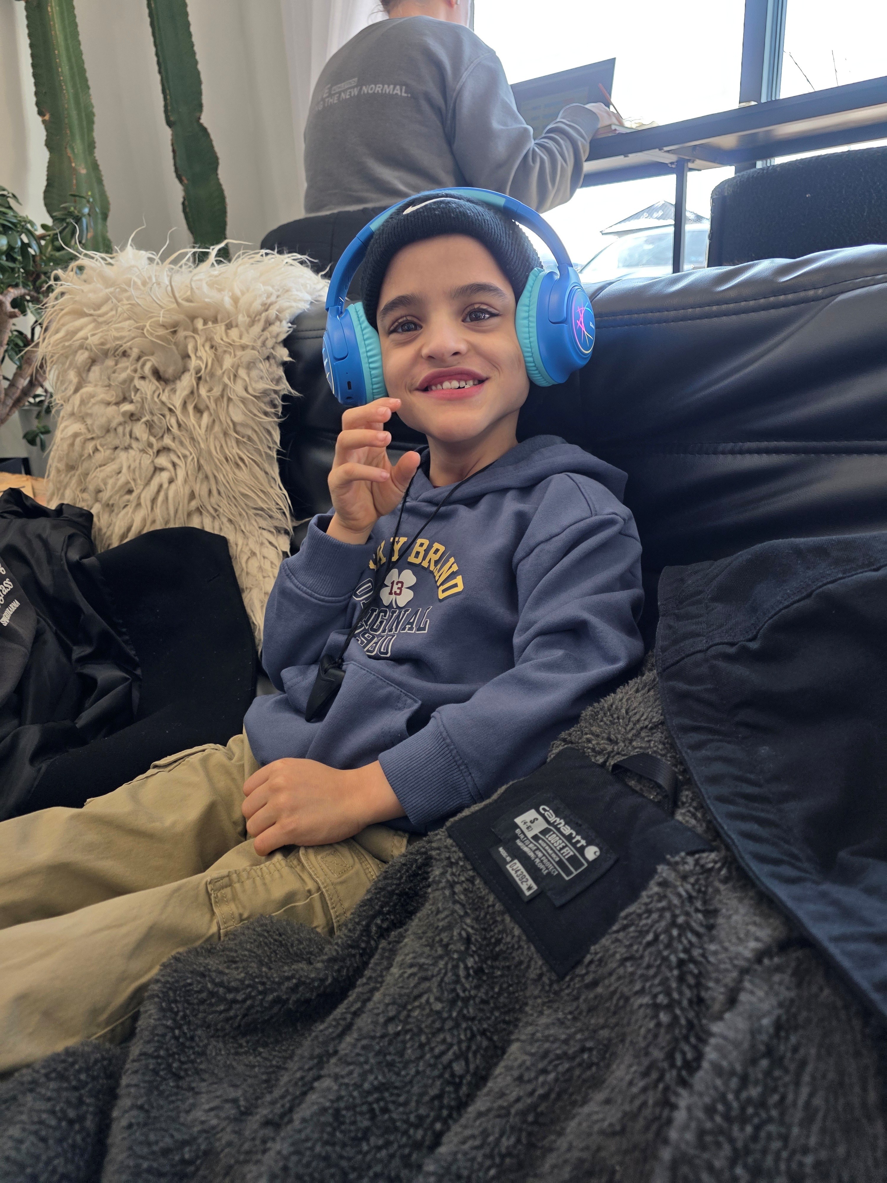 7-year-old Help Hope Live client Angelo Murphy wearing headphones.