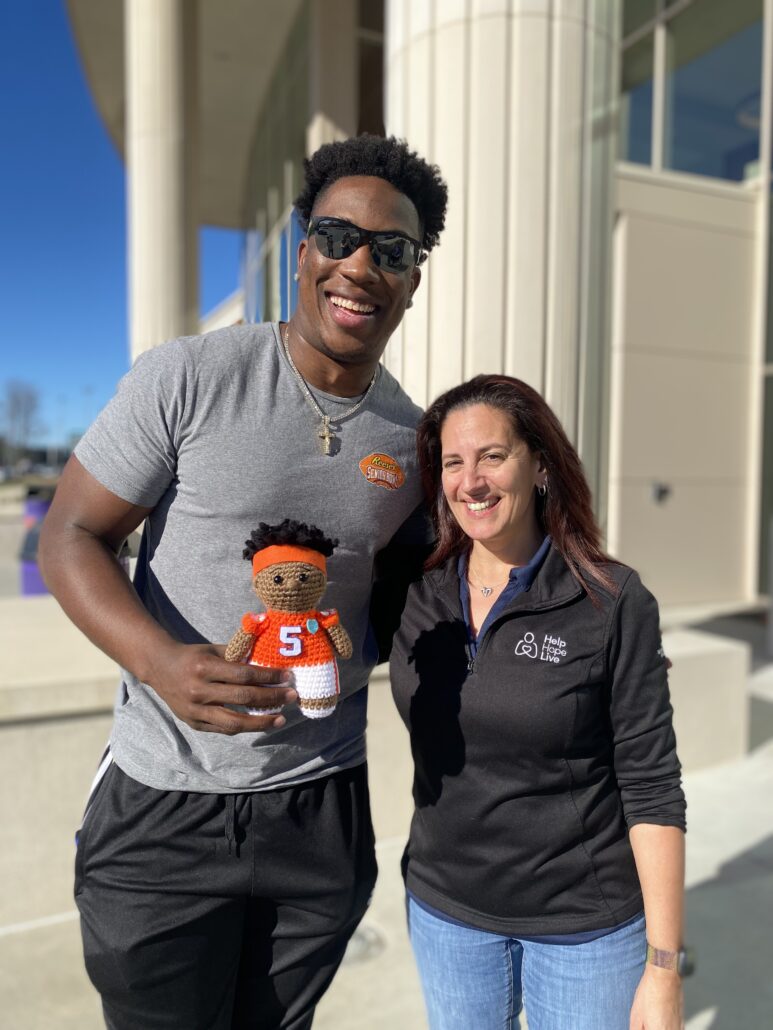 KJ Henry with Help Hope Live's Kelly Green and a Yeti or Knot knit version of KJ in Clemson orange.