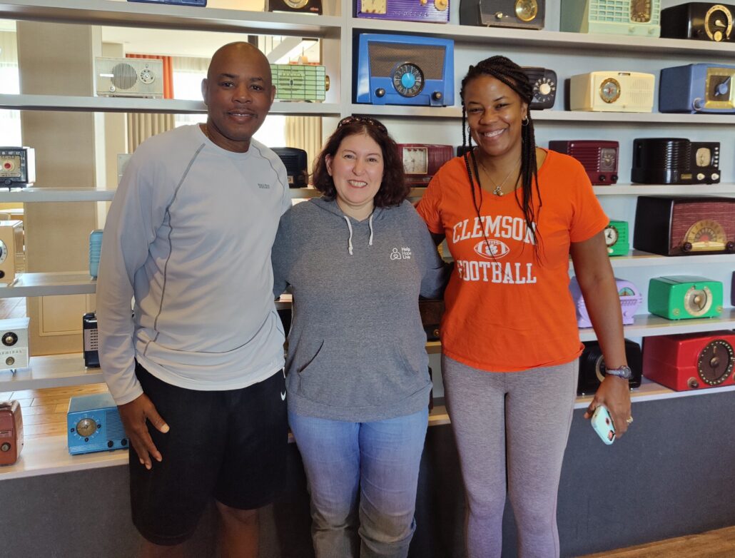 Keith Henry, Nicole Henry in a Clemson Football orange t-shirt, and Help Hope Live's Jen Smilg.