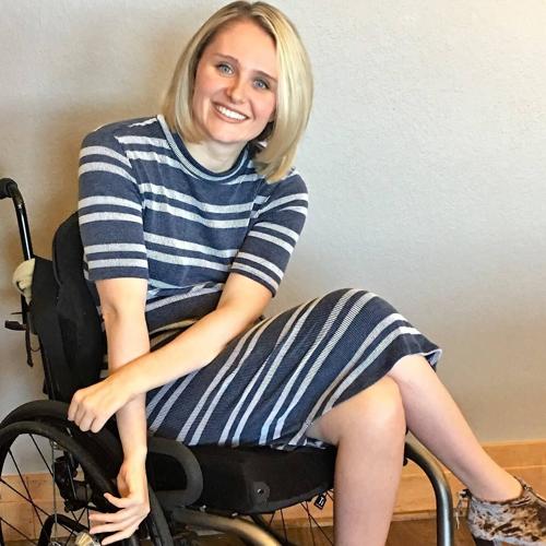 Lauren Shevchek is seated in her manual wheelchair with shoulder-length blonde hair.