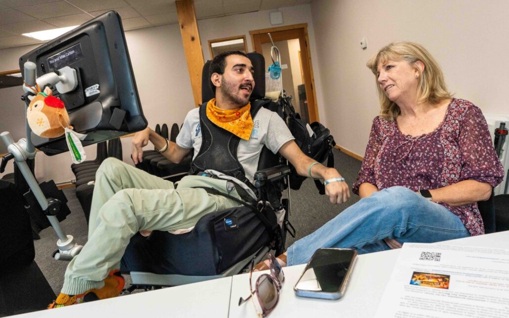 Yonan Matti smiles at friend and caregiver Liz Castagnera during an interview with the Times of San Diego in April 2026.
