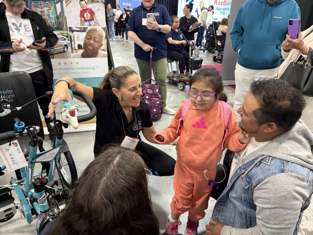 Kelly L Green with bike recipient Jeanney at Abilities Expo NY 2026.