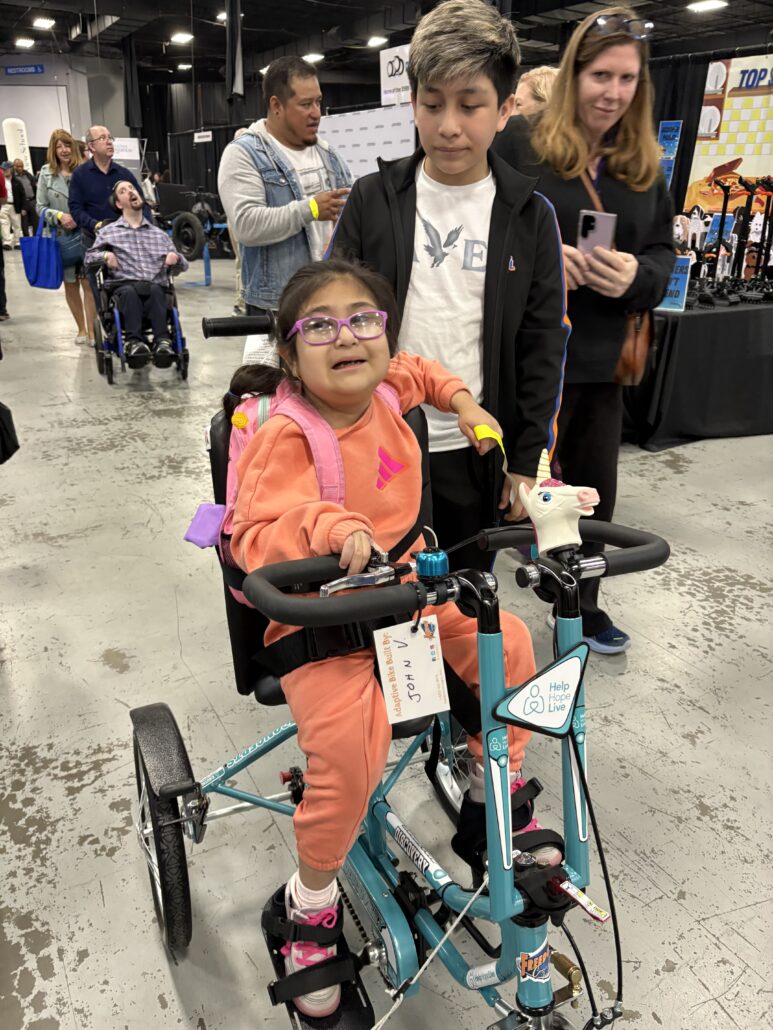 Jeanney seated on her new adaptive bike at Abilities Expo NY 2026.