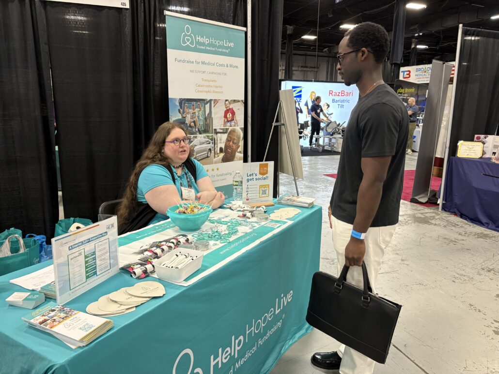 Stacia speaks to a visitor at the Help Hope Live booth at Abilities Expo NY 2026.