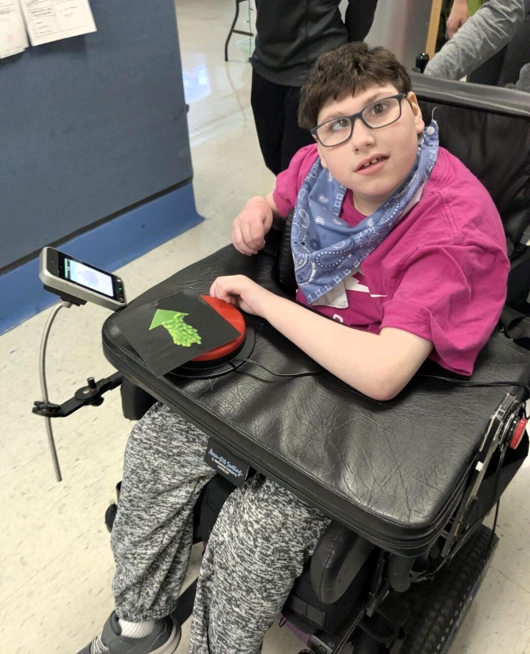 Teen Nick Lovecchio is seated in a power chair.
