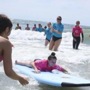 Amanda Parezo participates in adaptive surfing with Life Rolls On in Wildwood in 2026. Photo via WHYY.