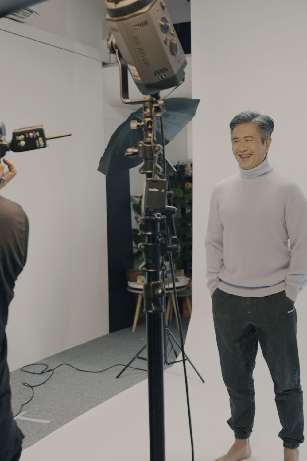 Man smiling in front of camera in a studio.