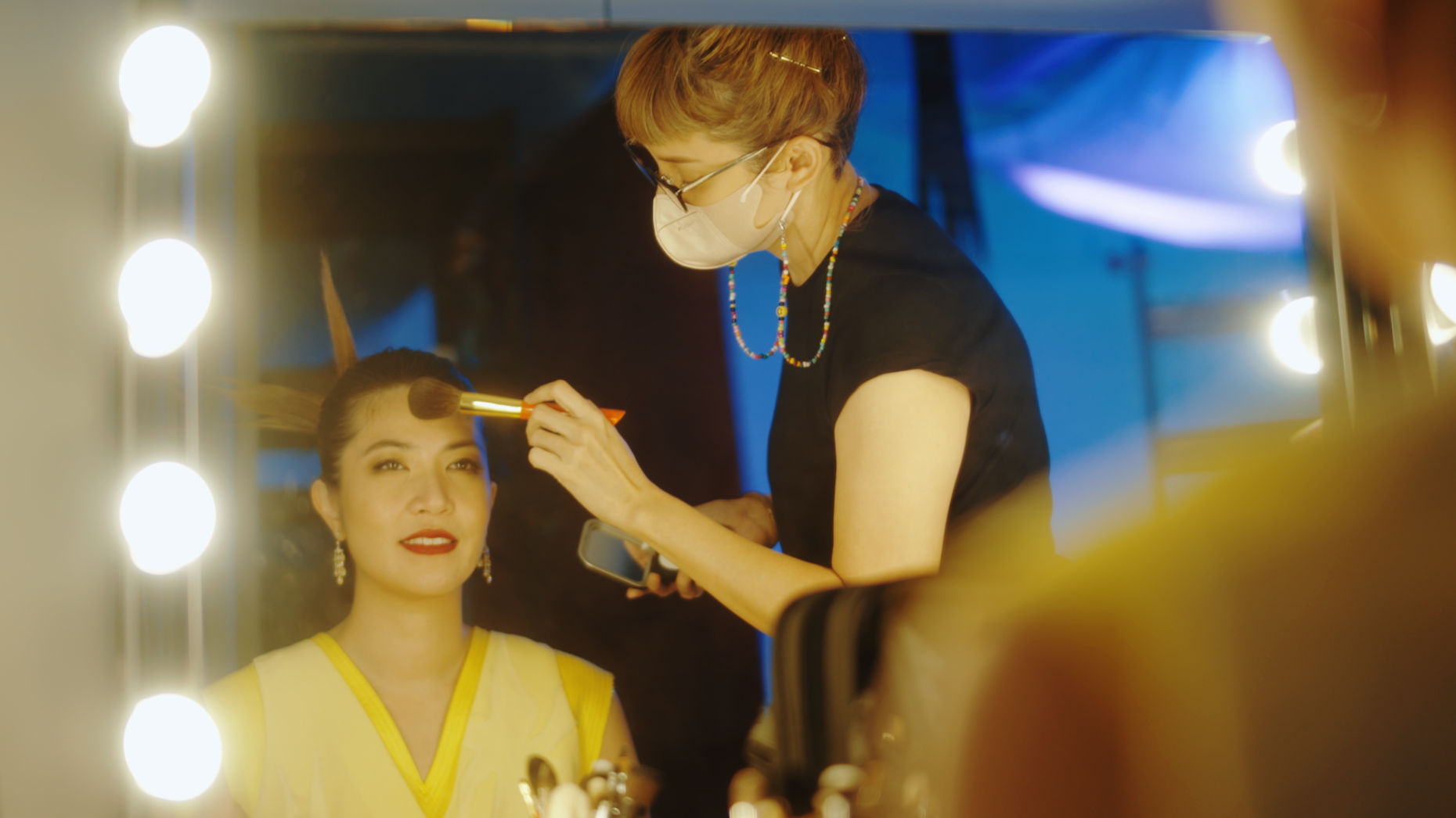 Woman getting her make-up done by a make-up artist.