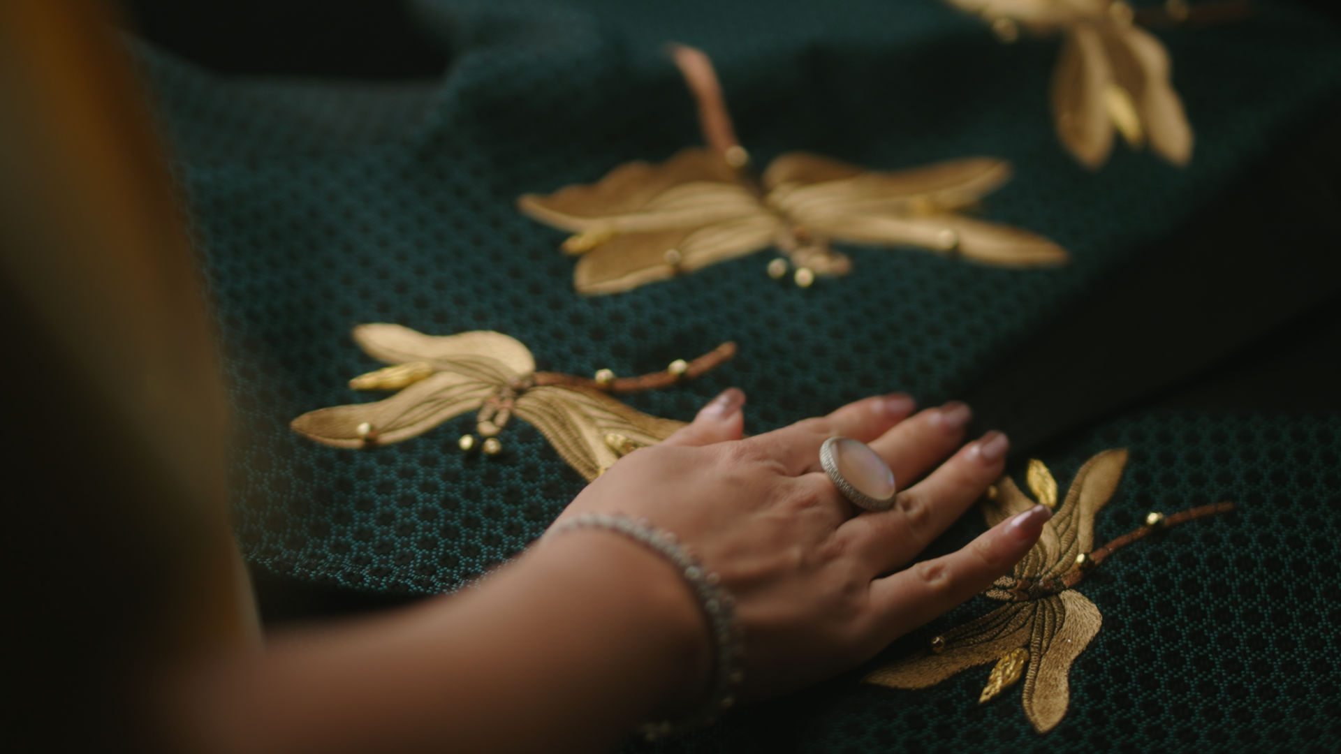 Hand on top of a green cloth.