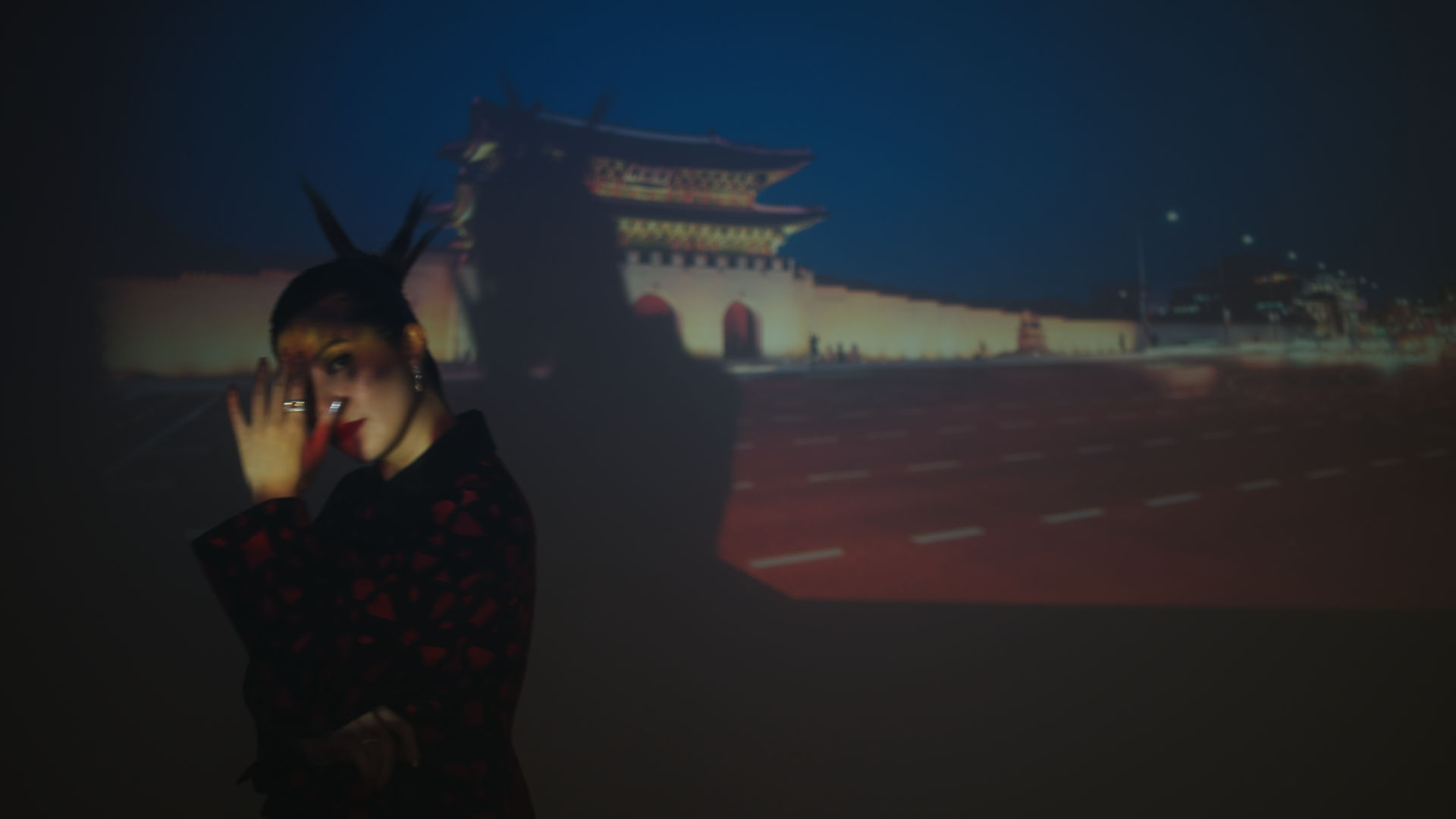 Woman standing in front of a projector.