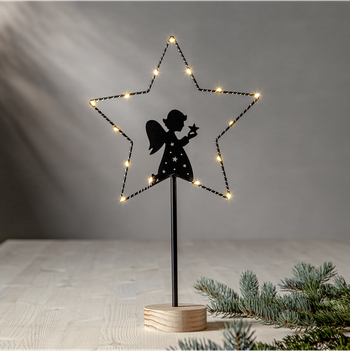 Lysande trådstjärna med ängelsiluett, en produkt från Nya Musik som utvecklar och engagerar människor i alla åldrar.