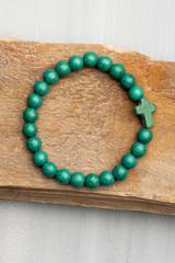 Armband kula, kors – Mörkgrön, en produkt från Nya Musik som utvecklar och engagerar människor i alla åldrar.