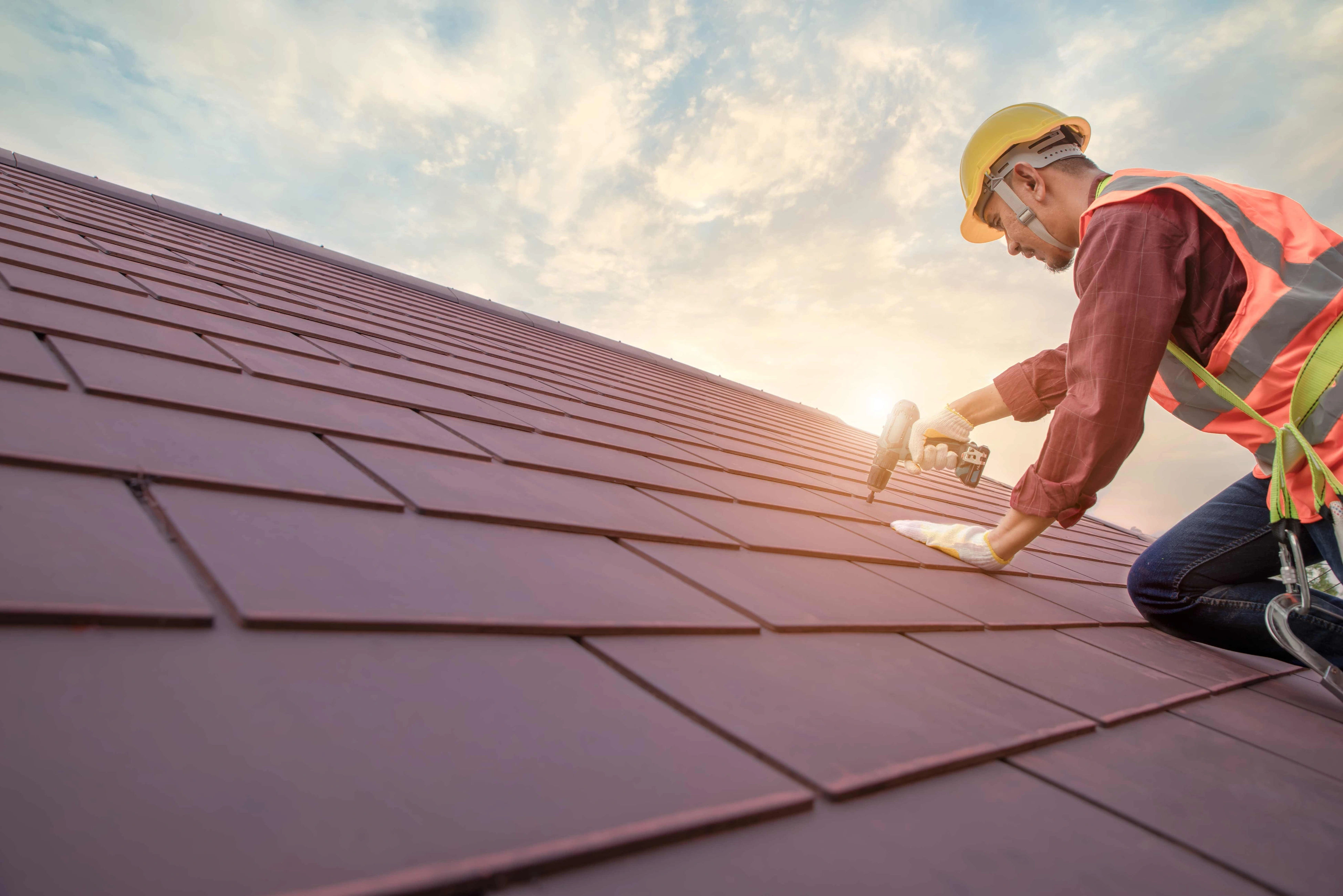 Professional roofing crew installing new shingles on a residential home