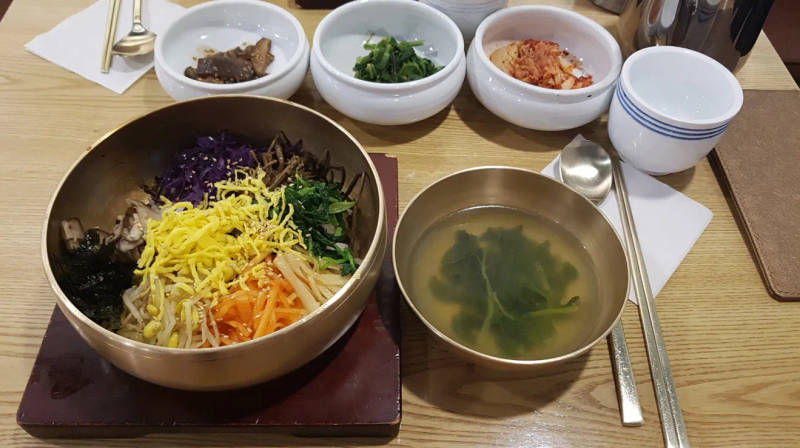 A Korean dining table set with a well-placed spoon and chopsticks.