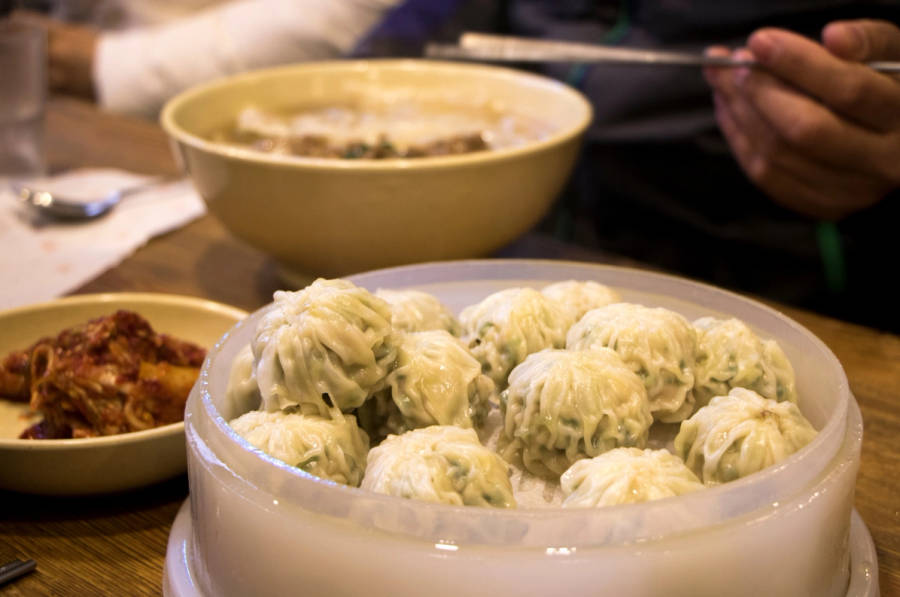 The dumplings, noodle soup, and kimchi at the restaurant Myeongdong Kyoja.